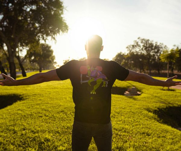 Person feeling energized and happy outdoors under the sun.